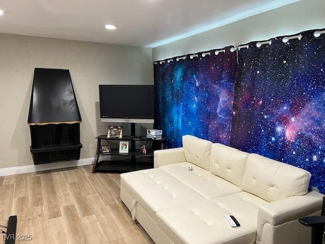living area with wood finished floors, recessed lighting, and baseboards