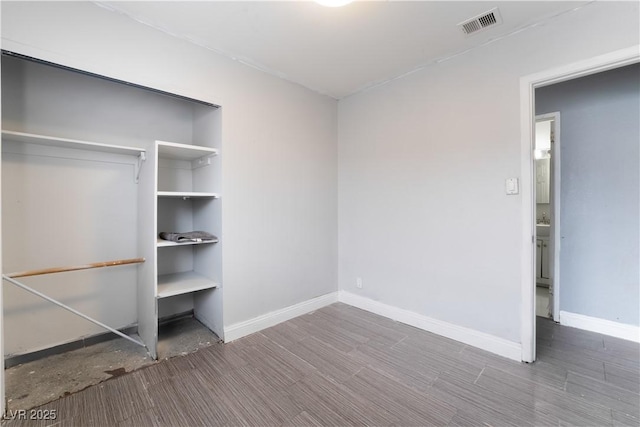 unfurnished bedroom with baseboards and visible vents
