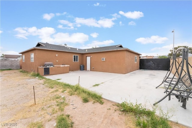 back of house with a patio, stucco siding, and fence
