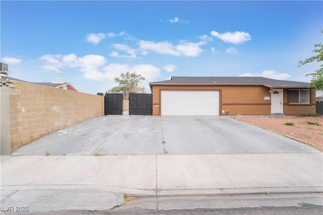 exterior space featuring stucco siding, fence, a gate, a garage, and driveway