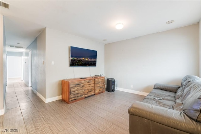 living area with visible vents and baseboards