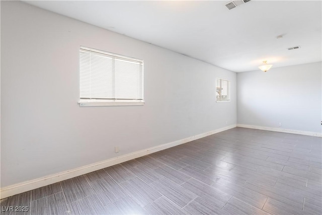 spare room featuring visible vents and baseboards