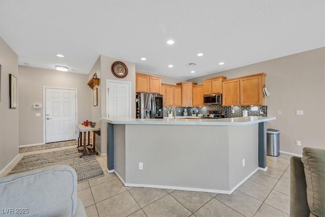 6072 Canter Glen Ave, Las Vegas, NV 89122 - kitchen with light countertops, light tile patterned floors, and stainless steel appliances