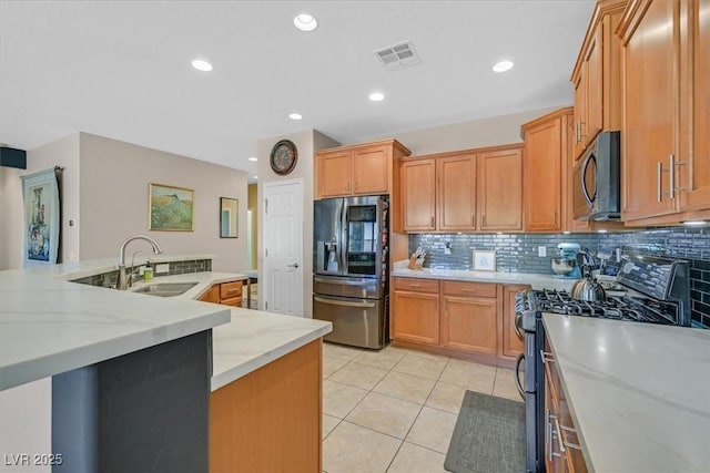 6072 Canter Glen Ave, Las Vegas, NV 89122 - kitchen with a sink, stainless steel appliances, light tile patterned floors, backsplash, and visible vents