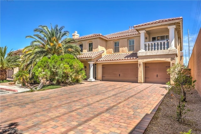 8454 Mondavi Hill Ct, Las Vegas, NV 89139 - mediterranean / spanish-style house with a garage, a balcony, decorative driveway, stucco siding, and a tile roof