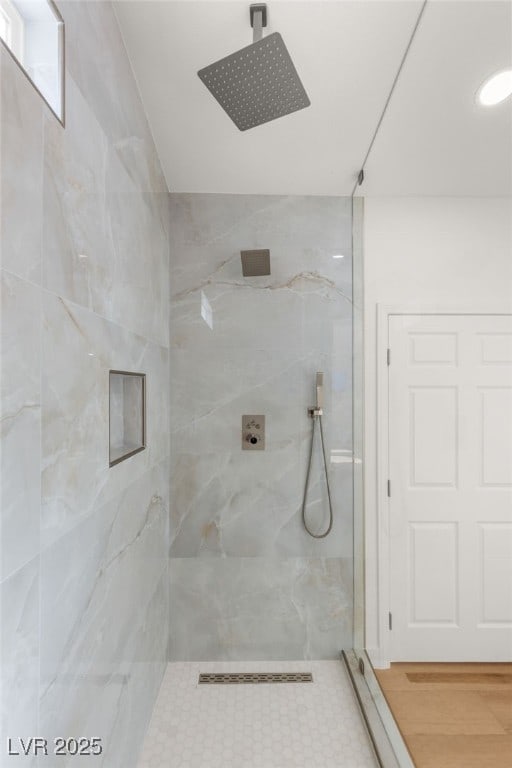 full bath featuring a marble finish shower