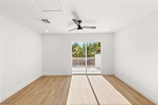 unfurnished room featuring light wood finished floors, visible vents, baseboards, and a ceiling fan