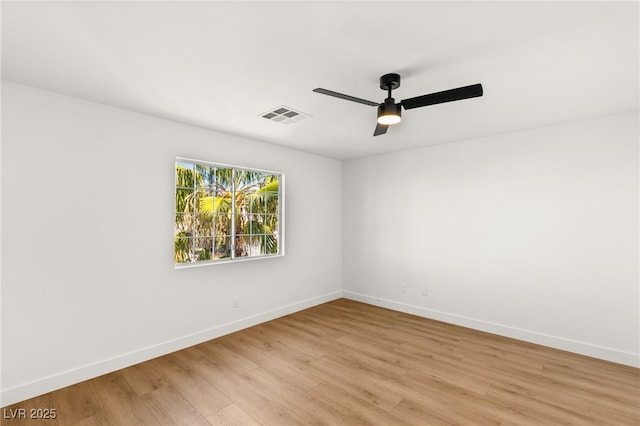 empty room with light wood-style flooring, visible vents, ceiling fan, and baseboards