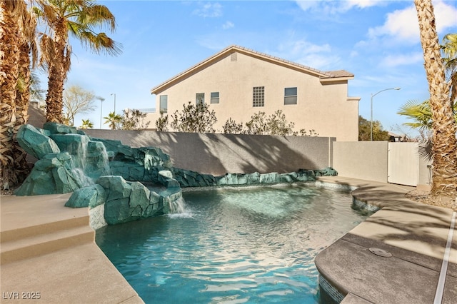 view of swimming pool featuring a fenced in pool and fence