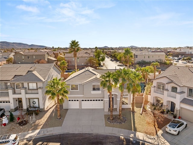 view of front of property with concrete driveway, a residential view, stucco siding, and a garage