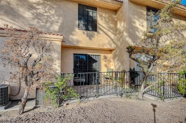 2851 S Valley View Blvd Unit 1139B, Las Vegas, NV 89102 - rear view of property featuring stucco siding, a patio area, fence, a tile roof, and central AC unit