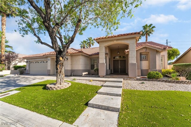 4176 Skywalker Ave, Las Vegas, NV 89120 - mediterranean / spanish home featuring stucco siding, a tiled roof, a garage, driveway, and a front yard