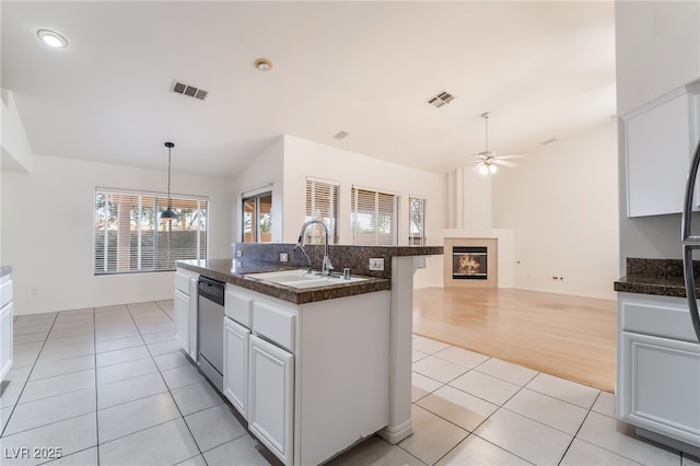 4176 Skywalker Ave, Las Vegas, NV 89120 - kitchen with a sink, stainless steel dishwasher, light tile patterned flooring, dark countertops, and plenty of natural light