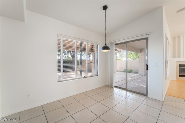 4176 Skywalker Ave, Las Vegas, NV 89120 - unfurnished dining area featuring light tile patterned flooring, lofted ceiling, and baseboards