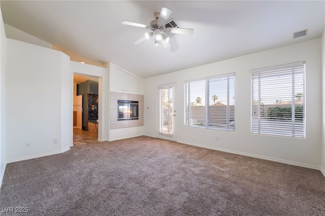 4176 Skywalker Ave, Las Vegas, NV 89120 - unfurnished living room featuring a ceiling fan, light colored carpet, vaulted ceiling, baseboards, and a tile fireplace