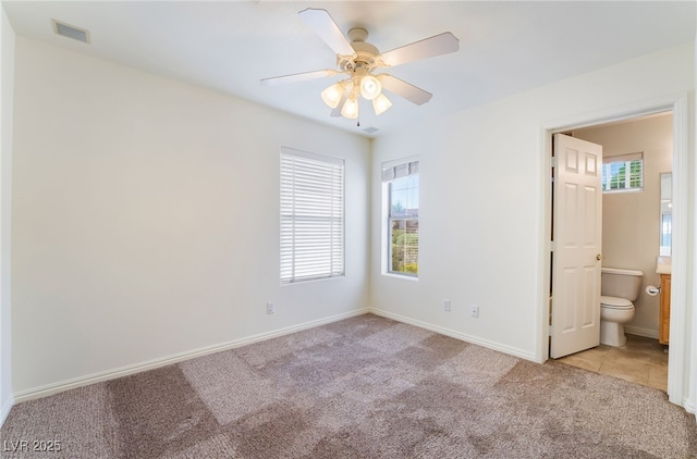 4176 Skywalker Ave, Las Vegas, NV 89120 - unfurnished bedroom featuring carpet, baseboards, a ceiling fan, and connected bathroom