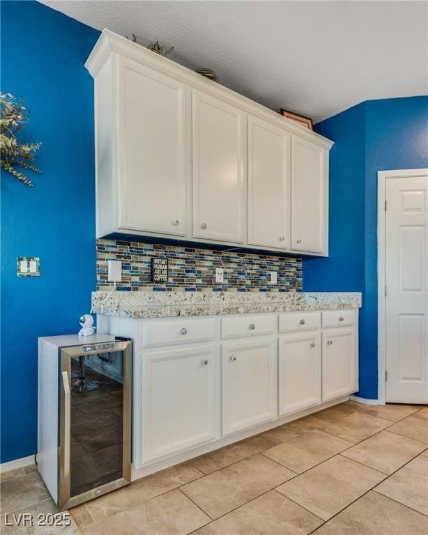 2558 Blossom Ave, Pahrump, NV 89048 - interior space with wine cooler, light tile patterned floors, tasteful backsplash, and baseboards