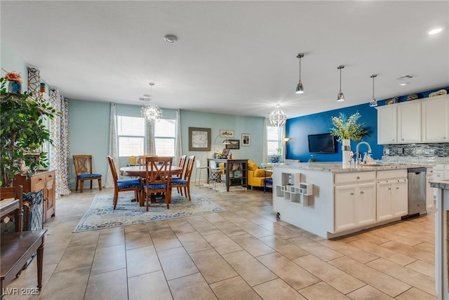 2558 Blossom Ave, Pahrump, NV 89048 - kitchen featuring a sink, hanging light fixtures, white cabinets, and a chandelier