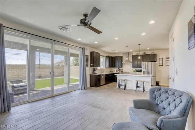 7445 Tinley Creek Ave, Las Vegas, NV 89113 - living area with visible vents, light wood-type flooring, a ceiling fan, and recessed lighting