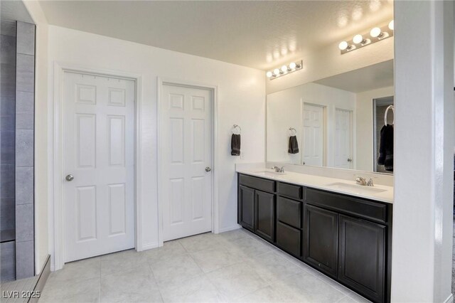 7445 Tinley Creek Ave, Las Vegas, NV 89113 - bathroom with tile patterned floors, double vanity, and a sink
