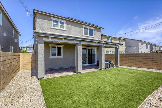 7445 Tinley Creek Ave, Las Vegas, NV 89113 - back of property featuring a yard, a fenced backyard, a patio, and stucco siding