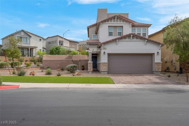 301 Resolute Ave, Henderson, NV 89011 - craftsman house featuring decorative driveway, a garage, stone siding, fence, and a residential view