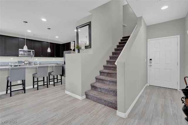 301 Resolute Ave, Henderson, NV 89011 - stairs featuring baseboards, wood finished floors, and recessed lighting