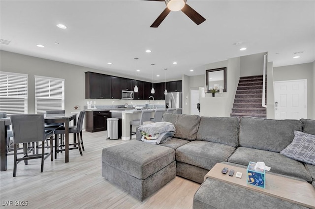 301 Resolute Ave, Henderson, NV 89011 - living room featuring ceiling fan, light wood finished floors, recessed lighting, and stairway