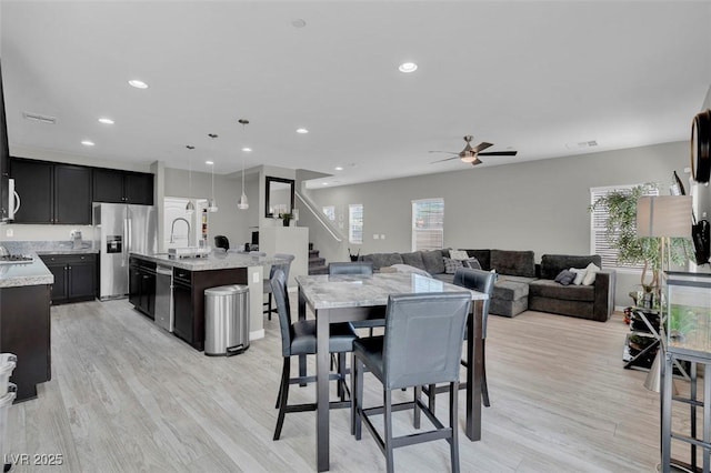 301 Resolute Ave, Henderson, NV 89011 - dining area featuring stairs, ceiling fan, light wood finished floors, and recessed lighting