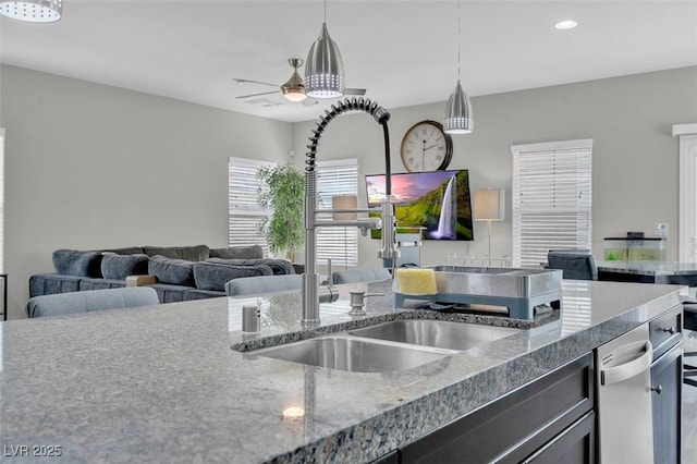 301 Resolute Ave, Henderson, NV 89011 - kitchen with a sink, ceiling fan, pendant lighting, open floor plan, and stone counters