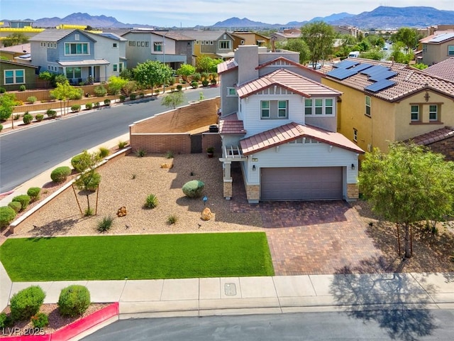 301 Resolute Ave, Henderson, NV 89011 - view of front facade featuring a residential view, a mountain view, driveway, and a garage
