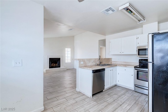 4732 Krissylouise Way, Las Vegas, NV 89121 - kitchen with white cabinets, visible vents, appliances with stainless steel finishes, a sink, and wood tiled floor