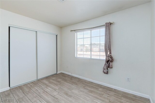 4732 Krissylouise Way, Las Vegas, NV 89121 - unfurnished bedroom featuring a closet, baseboards, and light wood finished floors