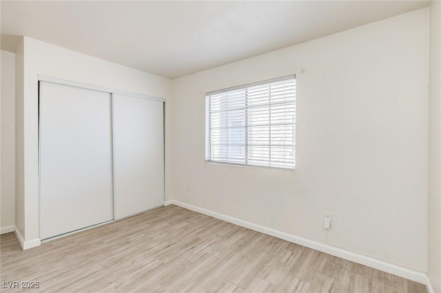 4732 Krissylouise Way, Las Vegas, NV 89121 - unfurnished bedroom featuring baseboards, light wood-style floors, and a closet