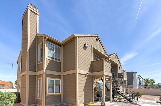 4732 Krissylouise Way, Las Vegas, NV 89121 - exterior space with a chimney, a balcony, and stairs
