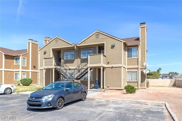 4732 Krissylouise Way, Las Vegas, NV 89121 - view of front facade featuring a chimney, fence, stairs, and uncovered parking