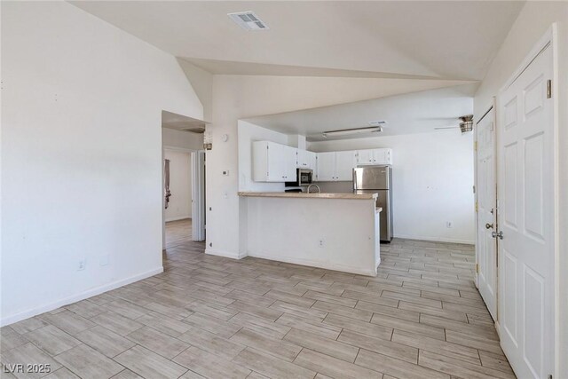 4732 Krissylouise Way, Las Vegas, NV 89121 - kitchen with visible vents, white cabinets, light wood-type flooring, a peninsula, and stainless steel appliances