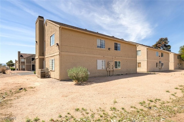 4732 Krissylouise Way, Las Vegas, NV 89121 - back of property with central AC, a chimney, and stucco siding