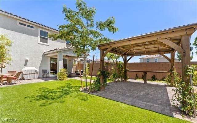 view of yard featuring a gazebo, a patio, and a fenced backyard