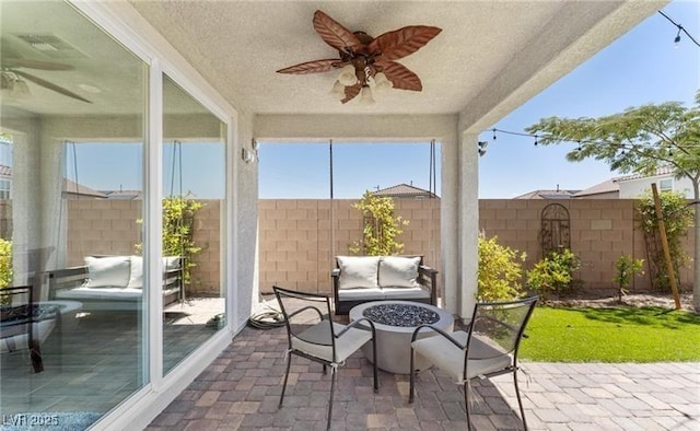 sunroom featuring a ceiling fan, brick floor, and a textured ceiling