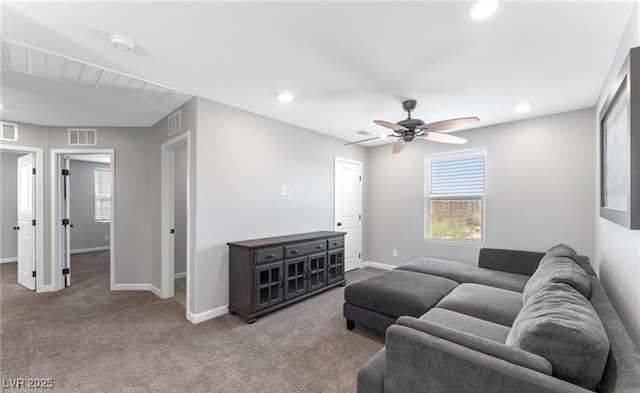 living room with carpet flooring, visible vents, and baseboards