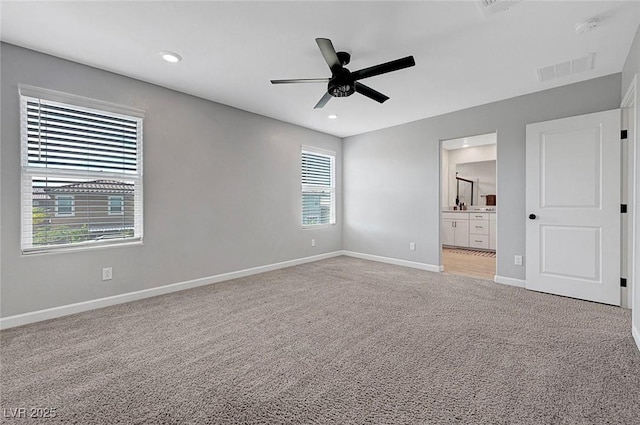 8349 Pollenzo Ave, Las Vegas, NV 89178 - unfurnished bedroom with light colored carpet, baseboards, ensuite bathroom, recessed lighting, and ceiling fan
