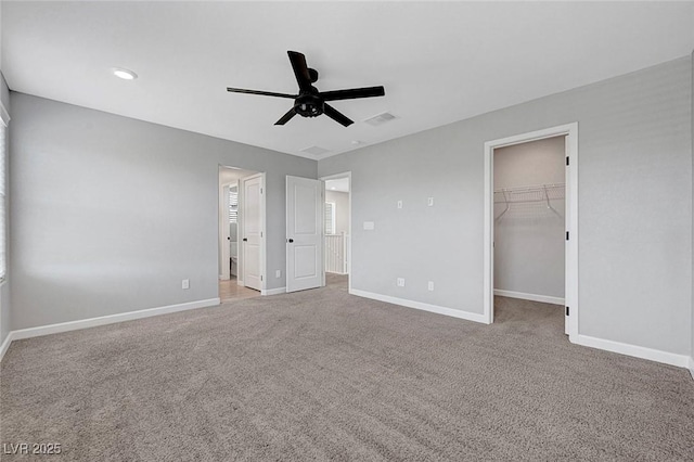 8349 Pollenzo Ave, Las Vegas, NV 89178 - unfurnished bedroom featuring carpet floors, baseboards, a walk in closet, and ceiling fan