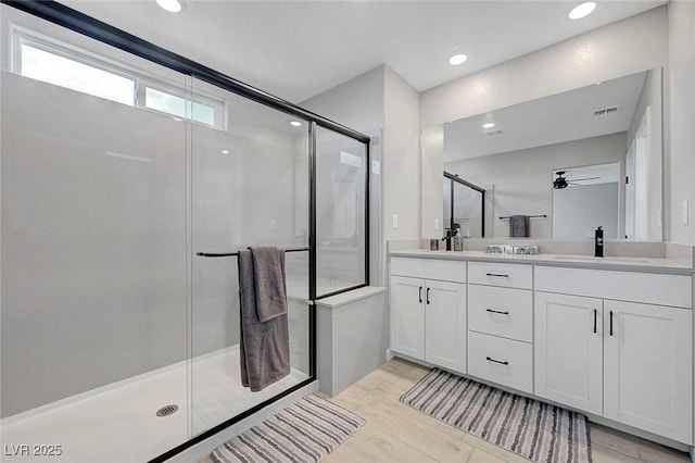 8349 Pollenzo Ave, Las Vegas, NV 89178 - bathroom with a shower stall, a ceiling fan, double vanity, recessed lighting, and wood finished floors
