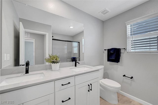 8349 Pollenzo Ave, Las Vegas, NV 89178 - full bath with toilet, a shower stall, double vanity, baseboards, and wood finished floors
