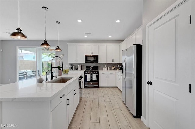 8349 Pollenzo Ave, Las Vegas, NV 89178 - kitchen featuring stainless steel appliances, a sink, tasteful backsplash, white cabinetry, and recessed lighting