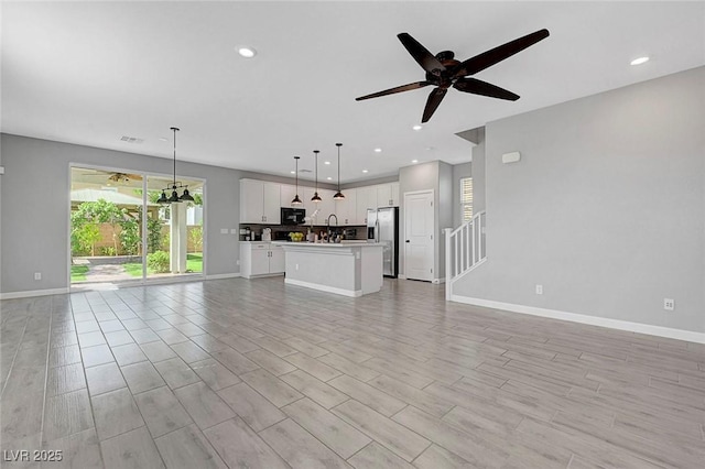 8349 Pollenzo Ave, Las Vegas, NV 89178 - unfurnished living room featuring ceiling fan, baseboards, recessed lighting, light wood-type flooring, and stairs