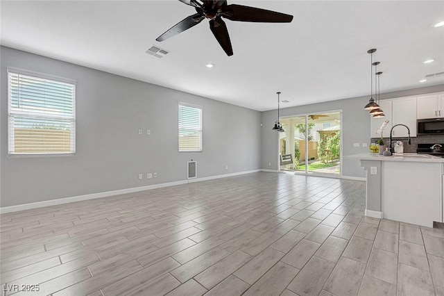 8349 Pollenzo Ave, Las Vegas, NV 89178 - unfurnished living room with plenty of natural light, baseboards, a ceiling fan, light wood-type flooring, and recessed lighting