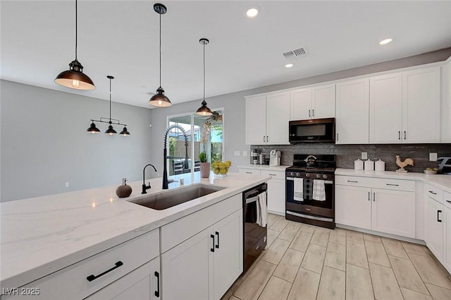 8349 Pollenzo Ave, Las Vegas, NV 89178 - kitchen with stainless steel gas range, a sink, black dishwasher, decorative backsplash, and pendant lighting