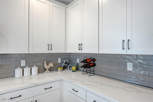 8349 Pollenzo Ave, Las Vegas, NV 89178 - kitchen with white cabinets, tasteful backsplash, and light stone countertops